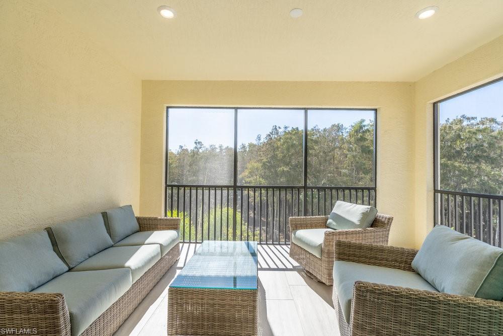 16364 Viansa Way, Unit 202 Naples, FL 34110 - Photo 24 of 39 a living room with furniture and a large window