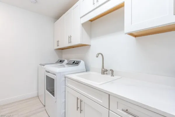 a utility room with sink dryer and washer