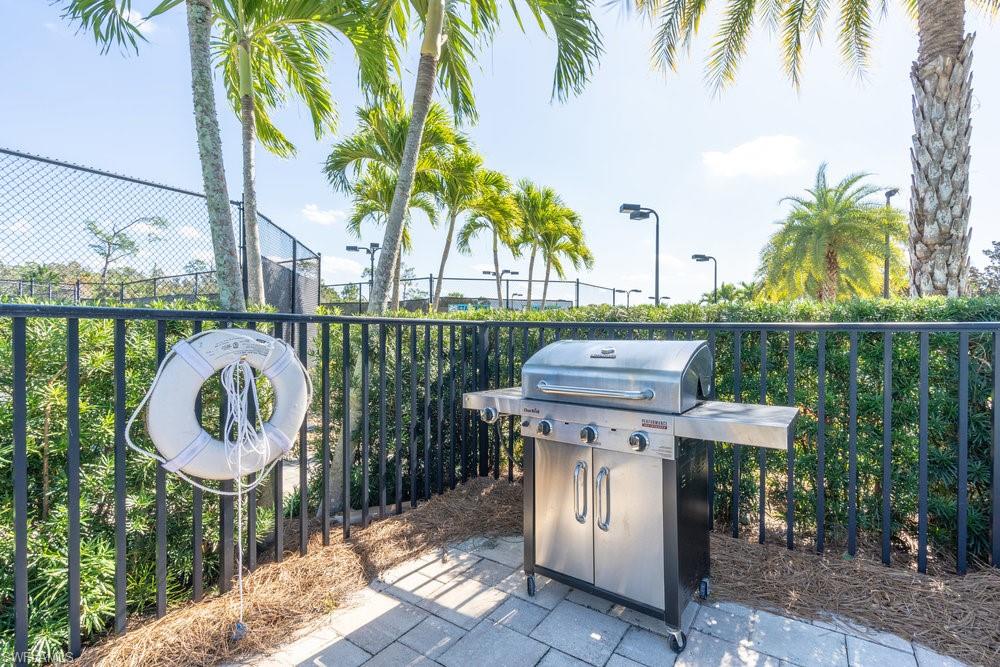 16364 Viansa Way, Unit 202 Naples, FL 34110 - Photo 27 of 39 a view of a chair and table in backyard of the house