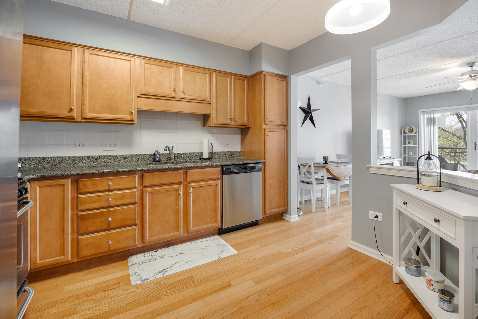225 Main Street, Unit 216 Roselle, IL 60172 - Photo 11 of 20 a kitchen with a sink a stove and cabinets