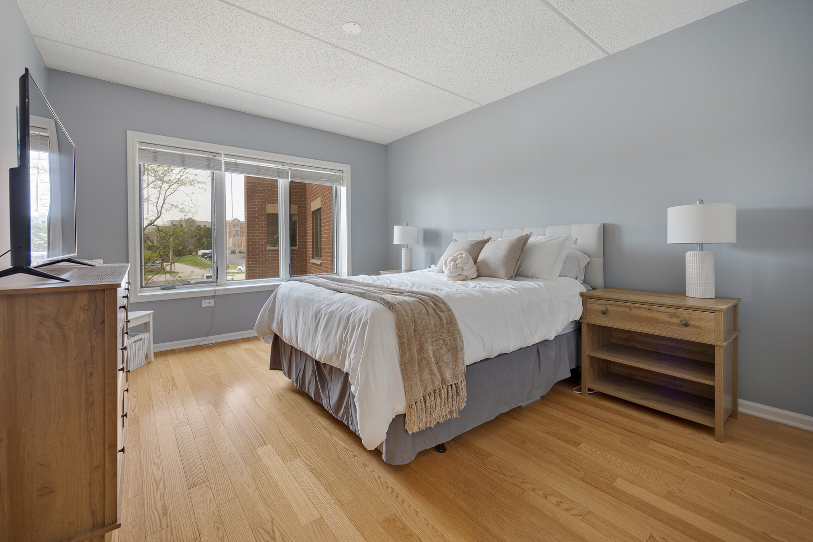 225 Main Street, Unit 216 Roselle, IL 60172 - Photo 13 of 20 a bedroom with a bed and a large window