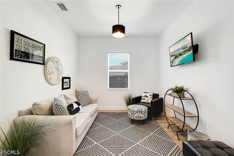 a living room with furniture a rug and a window