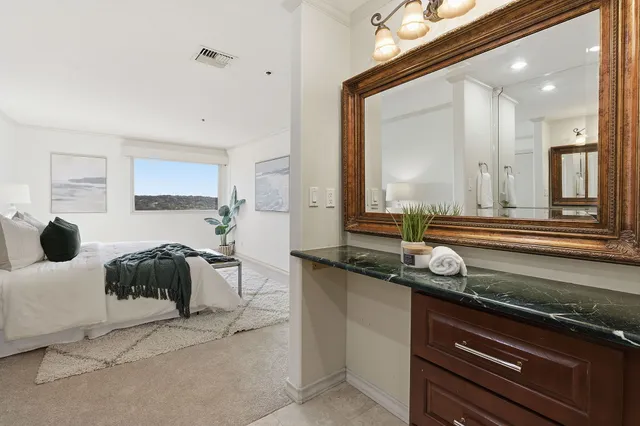 a bedroom with a bed and a large mirror