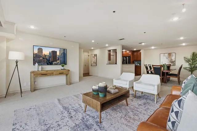a living room with furniture and kitchen view