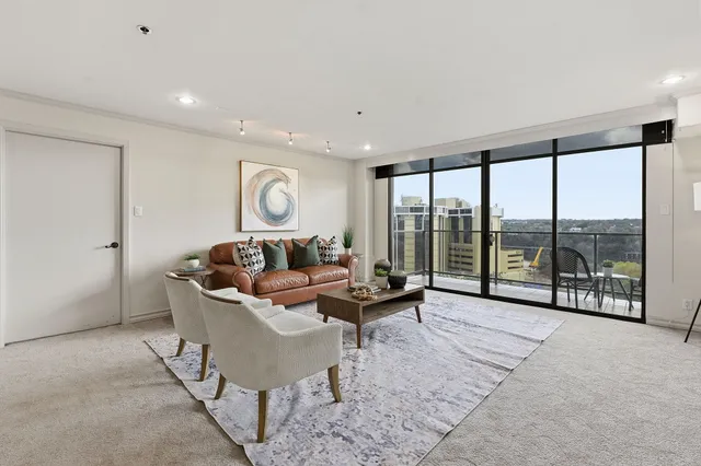 a living room with furniture and large windows