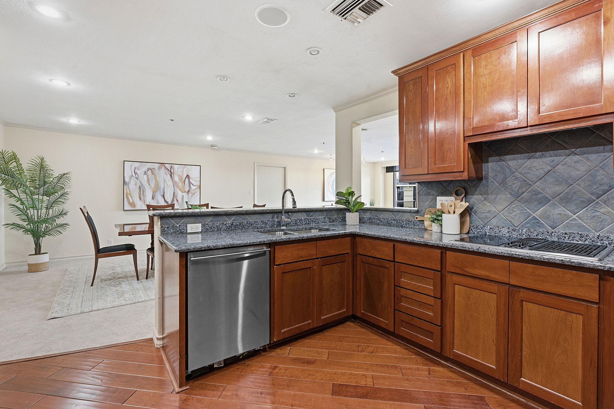 40 North Interstate Highway 35, Unit 10B4 Austin, TX 78701 - Photo 10 of 39 a kitchen with stainless steel appliances granite countertop wooden cabinets a sink and dishwasher