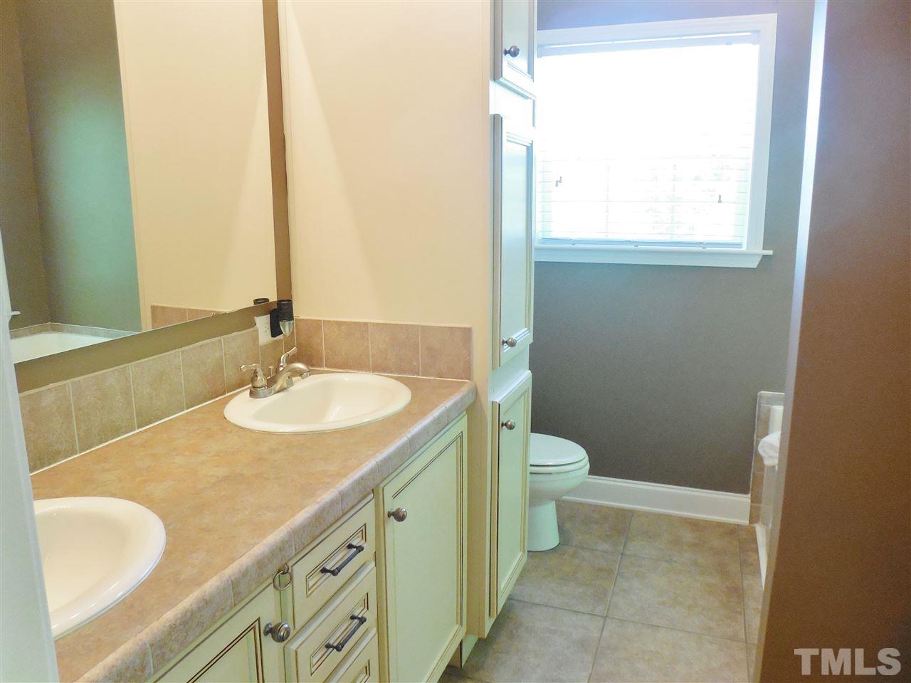 924 Whitt Town Road Roxboro, NC 27574 - Photo 11 of 17 a bathroom with a granite countertop sink toilet and mirror