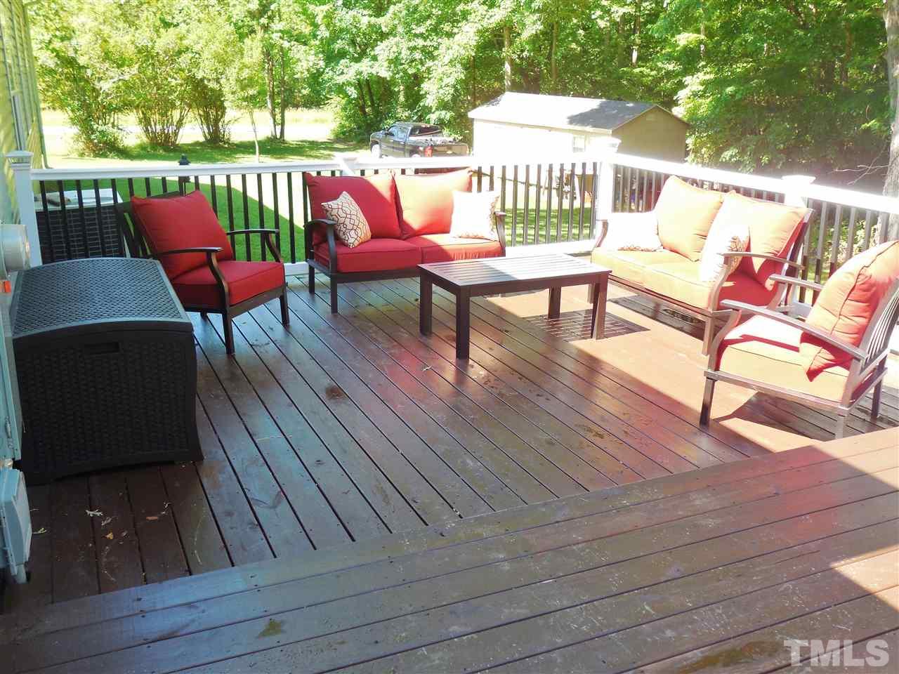 924 Whitt Town Road Roxboro, NC 27574 - Photo 15 of 17 an outdoor sitting area with furniture and wooden floor