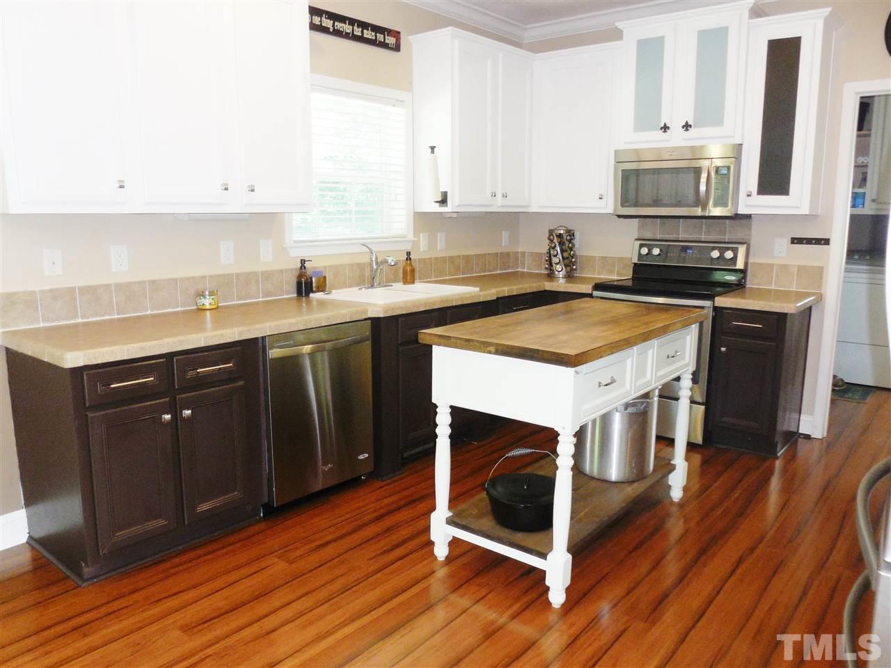 924 Whitt Town Road Roxboro, NC 27574 - Photo 5 of 17 a kitchen with a stove sink and cabinets