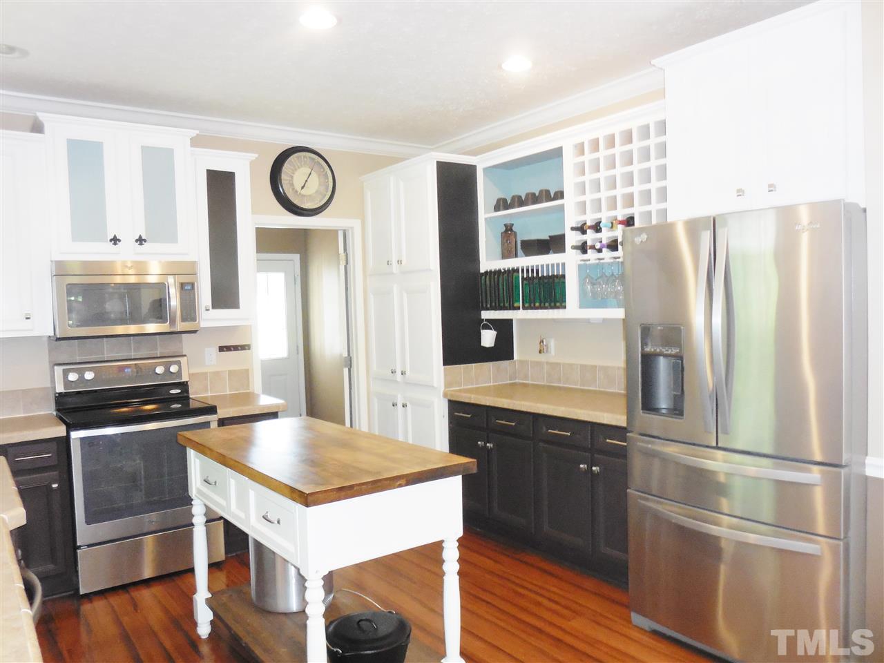 924 Whitt Town Road Roxboro, NC 27574 - Photo 7 of 17 a kitchen with stainless steel appliances a stove a refrigerator and a refrigerator