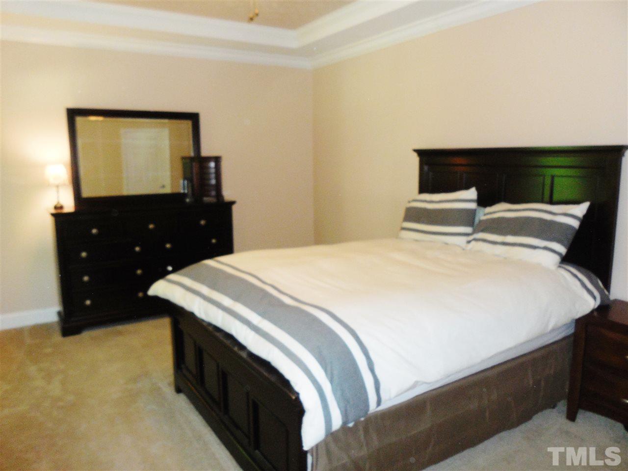 924 Whitt Town Road Roxboro, NC 27574 - Photo 9 of 17 a bedroom with a bed and a flat tv screen on dresser