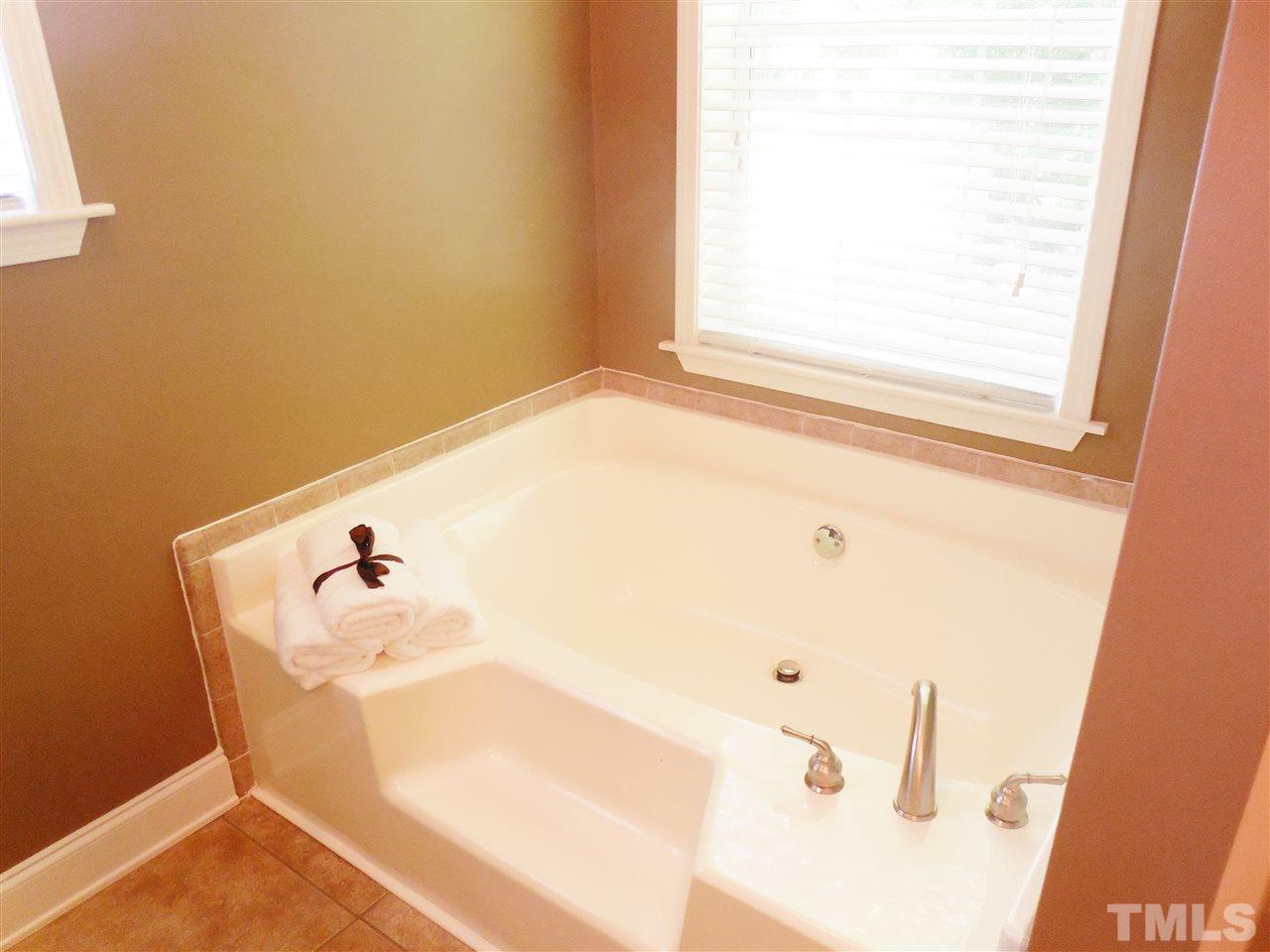 924 Whitt Town Road Roxboro, NC 27574 - Photo 10 of 17 a bathroom with a bathtub and a window