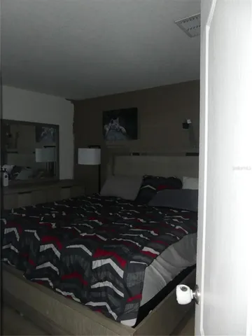 a room with water heater and wooden cabinets