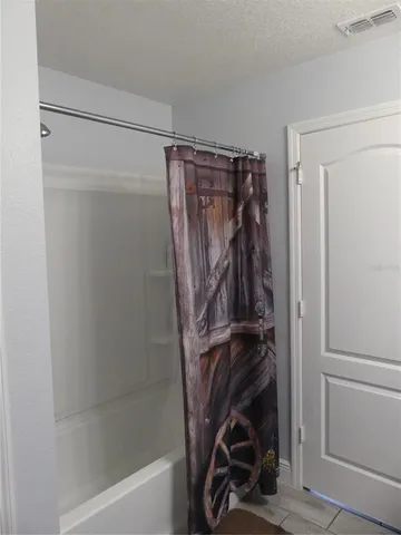 a view of walk in closet with clothes