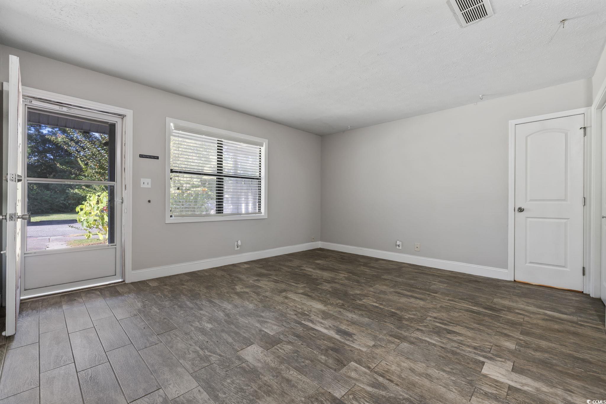 801 Burcale Road, Unit I1 Myrtle Beach, SC 29579 - Photo 17 of 27 Unfurnished room featuring dark wood-type flooring and baseboards