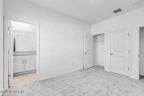 a bathroom with a granite countertop sink a toilet and bathtub