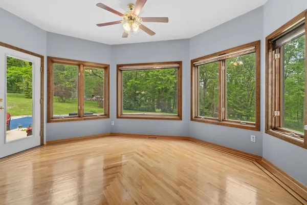 a kitchen with white cabinets and chairs
