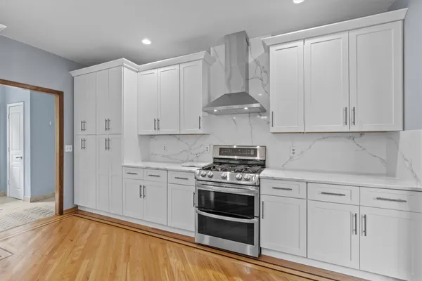 a spacious bathroom with a tub sink and mirror