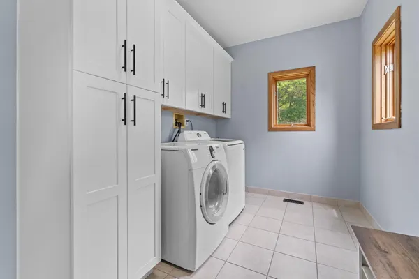 a bathroom with a tub sink and mirror