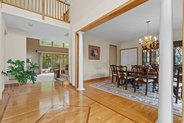 a dining room filled with lots of tables a potted plant and open kitchen view