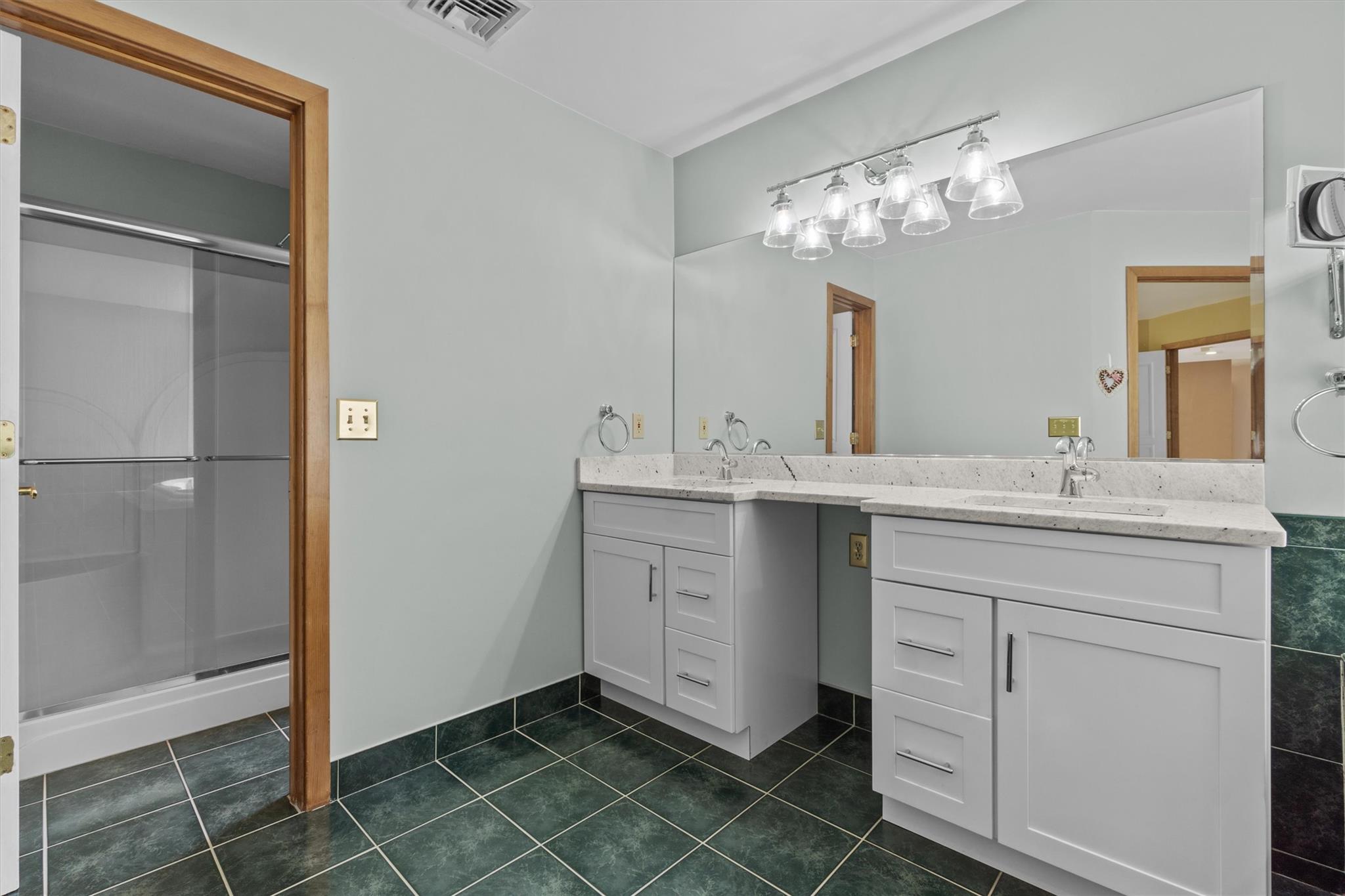 115 Moffat Road Washingtonville, NY 10992 - Photo 31 of 50 a bathroom with a double vanity sink a mirror and a shower