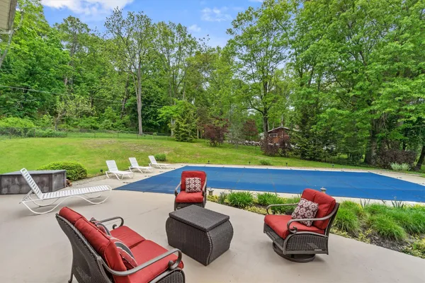 a house with a big yard and large trees