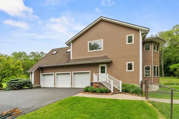 a view of pool with lawn chairs and plants