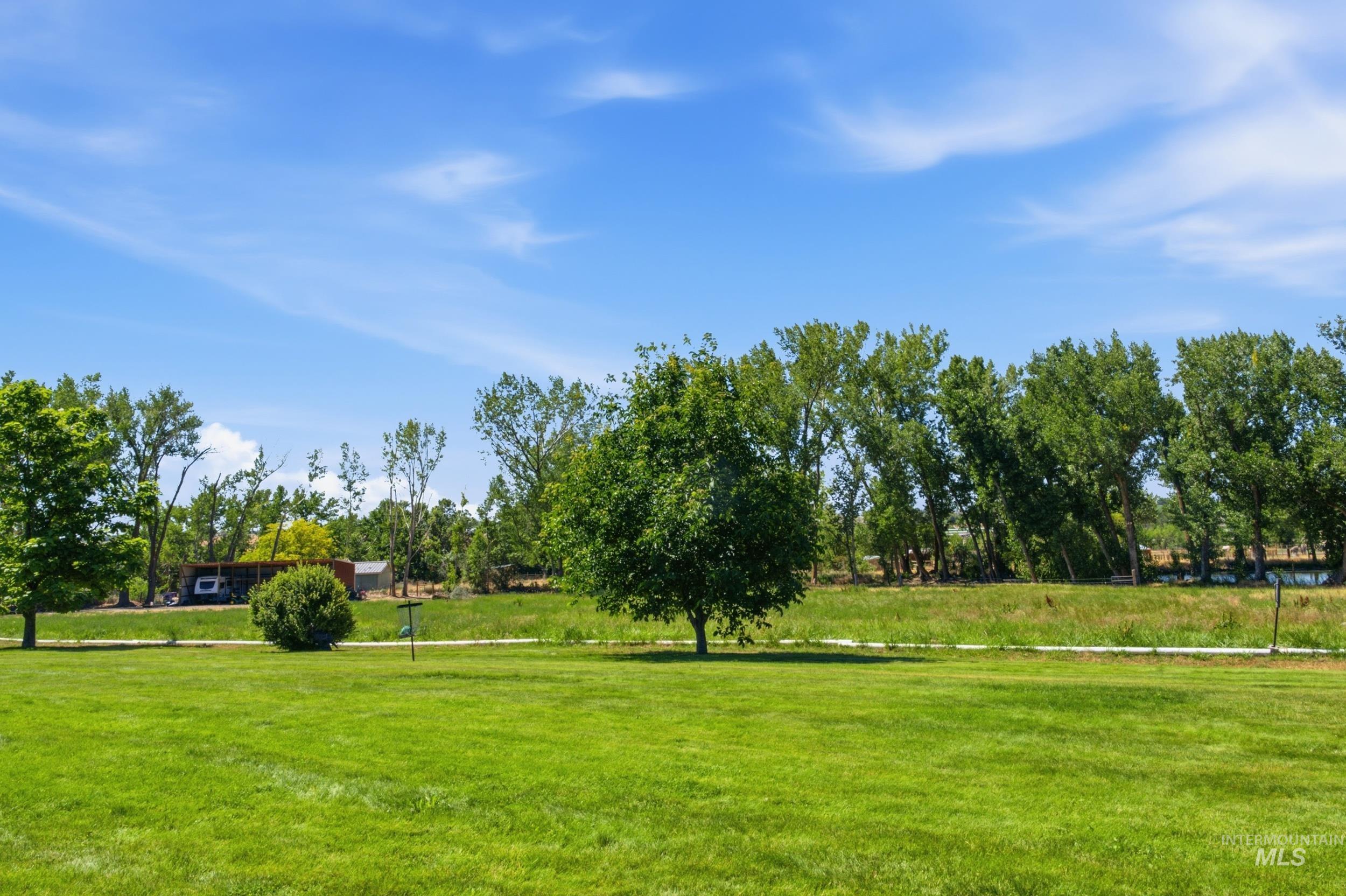 7781 Redmon Road Caldwell, ID 83607 - Photo 16 of 50 Covered concrete patio with overhead wood beam structure