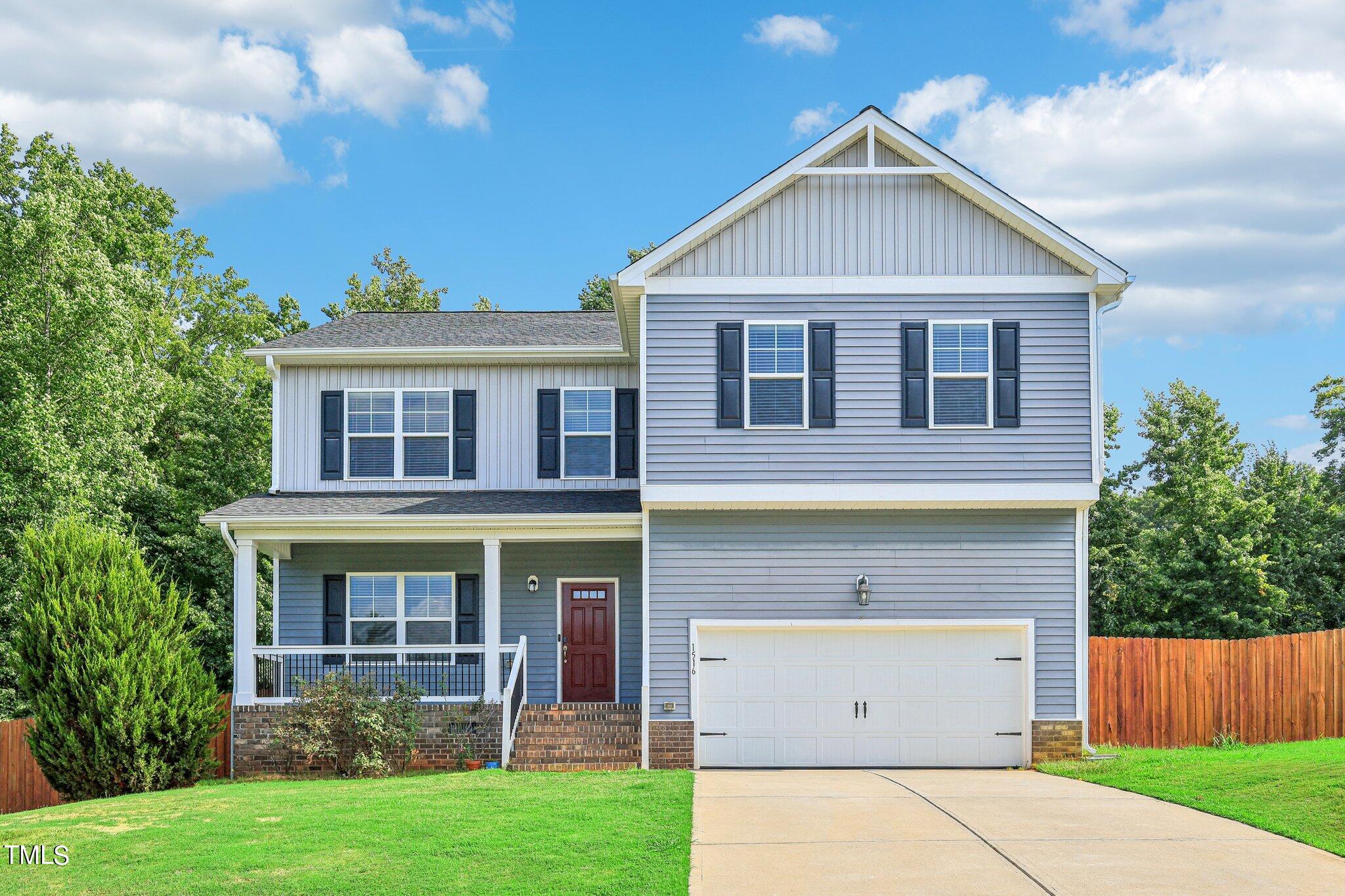 1516 Yakimas Road Raleigh, NC 27603 - Photo 1 of 27 a front view of a house with a yard and garage