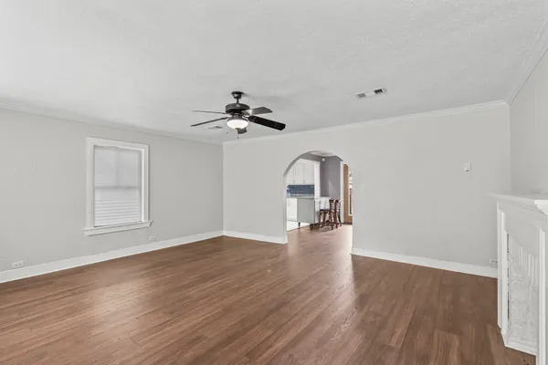 a view of empty room with wooden floor