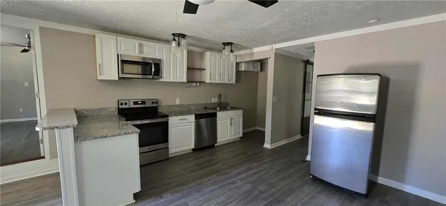 a kitchen with a refrigerator stove and microwave