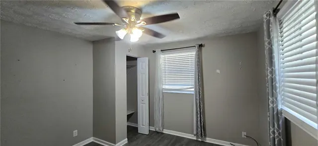 a view of a livingroom with a ceiling fan and window
