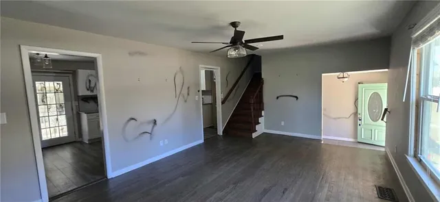 a view of a hallway view with wooden floor and staircase