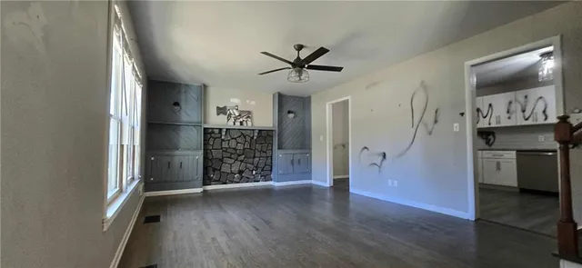 a view of a hallway with wooden floor and entryway