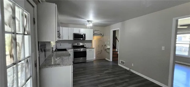 a kitchen with stainless steel appliances a refrigerator stove and microwave