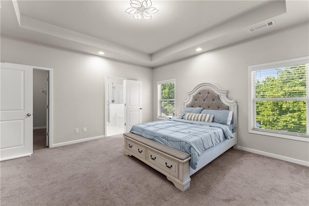 2228 Lakeview Bend Way Buford, GA 30519 - Photo 13 of 36 a spacious bedroom with a bed and a window