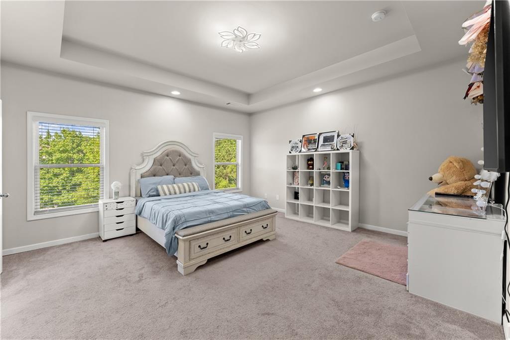 2228 Lakeview Bend Way Buford, GA 30519 - Photo 14 of 36 a spacious bedroom with a bed and a window