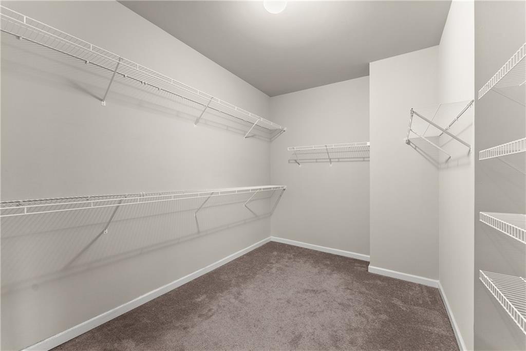 2228 Lakeview Bend Way Buford, GA 30519 - Photo 15 of 36 a view of a room with racks on the wall