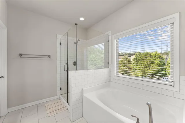a bathroom with a bathtub and a shower