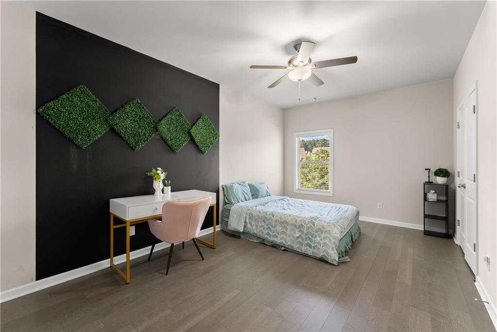 2228 Lakeview Bend Way Buford, GA 30519 - Photo 21 of 36 a bedroom with a bed and a chandelier