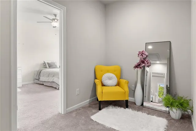 a living room with furniture and flowers