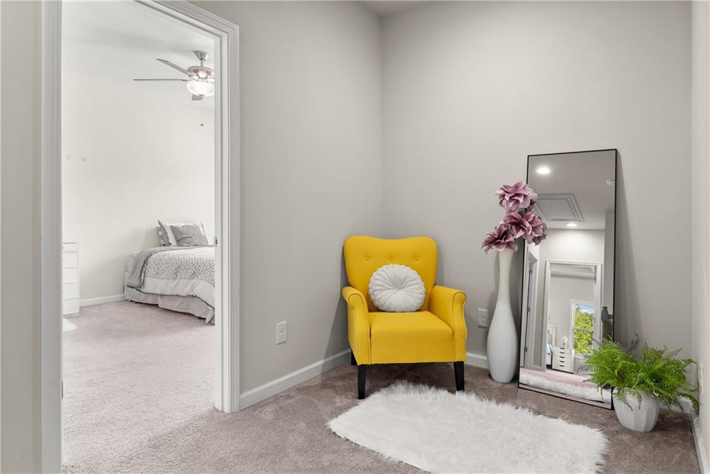 2228 Lakeview Bend Way Buford, GA 30519 - Photo 23 of 36 a living room with furniture and flowers