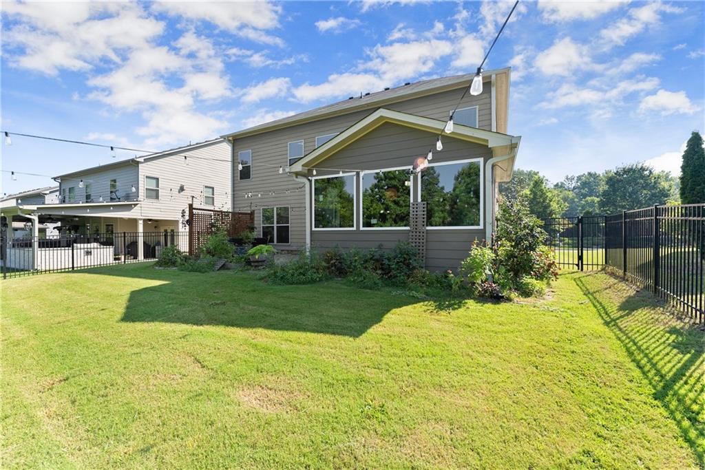 2228 Lakeview Bend Way Buford, GA 30519 - Photo 27 of 36 a view of a white house with a big yard and potted plants