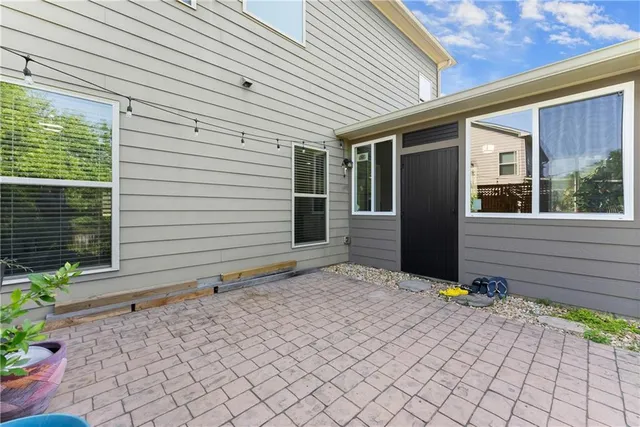 a front view of a house with plants