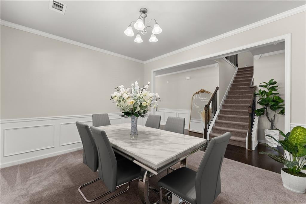 2228 Lakeview Bend Way Buford, GA 30519 - Photo 3 of 36 a view of a dining room with furniture and wooden floor