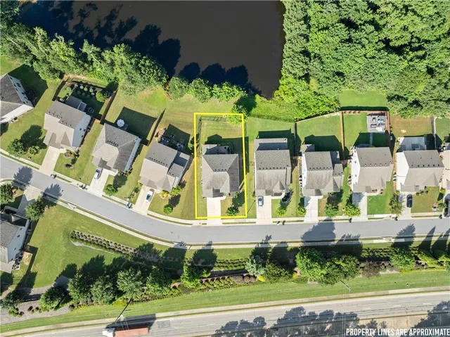 an aerial view of a house with a yard and potted plants