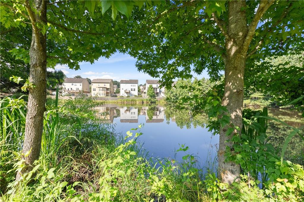 2228 Lakeview Bend Way Buford, GA 30519 - Photo 32 of 36 a view of a garden with lawn chairs under an umbrella