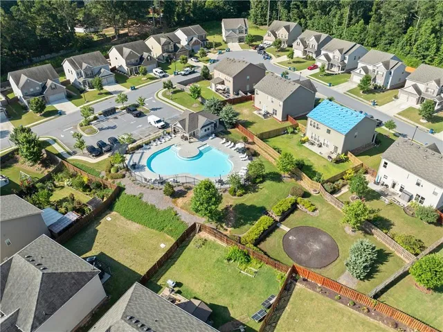 an aerial view of a house with yard swimming pool and outdoor seating