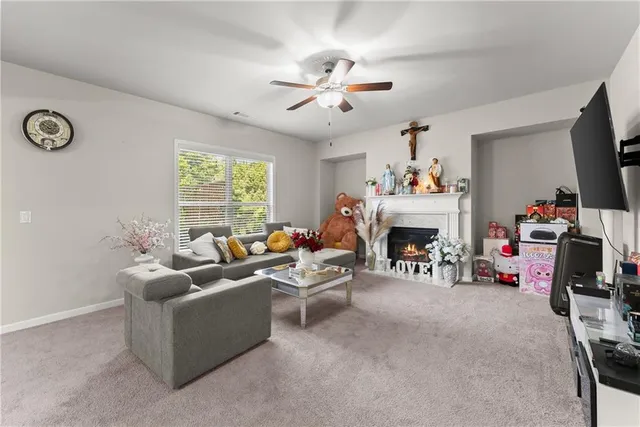 a living room with furniture a fireplace and a flat screen tv