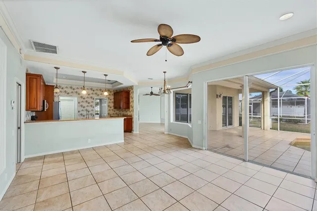 a view of a room with a ceiling fan and wooden floor